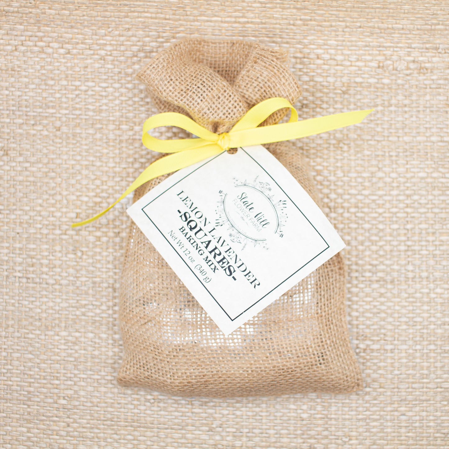 Lemon Lavender Squares Baking Mix, wrapped in burlap with a yellow ribbon.
